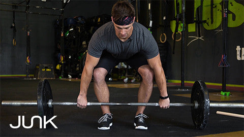 man in gray shirt performing deadlift