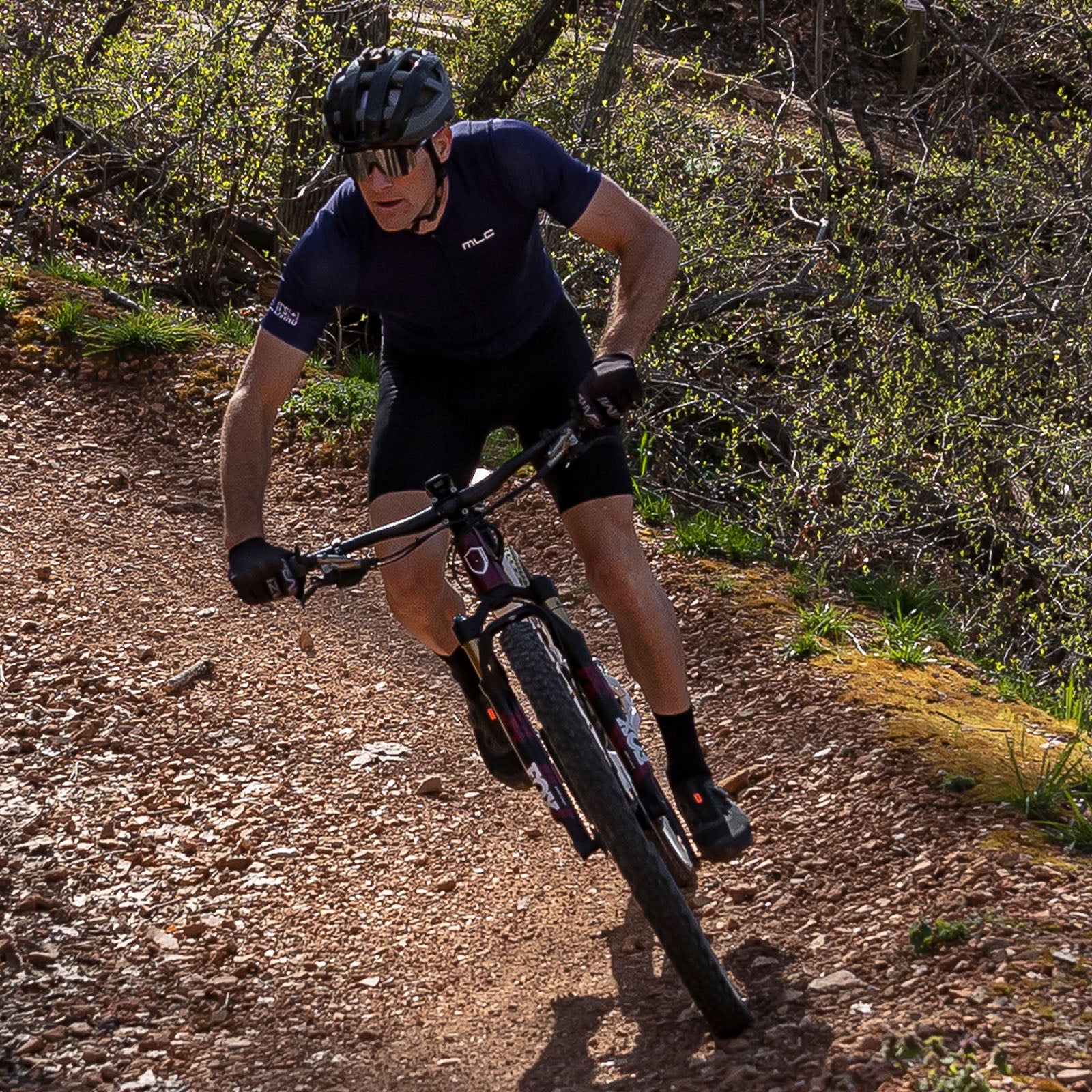 A man on a mountain bike riding down a trail.