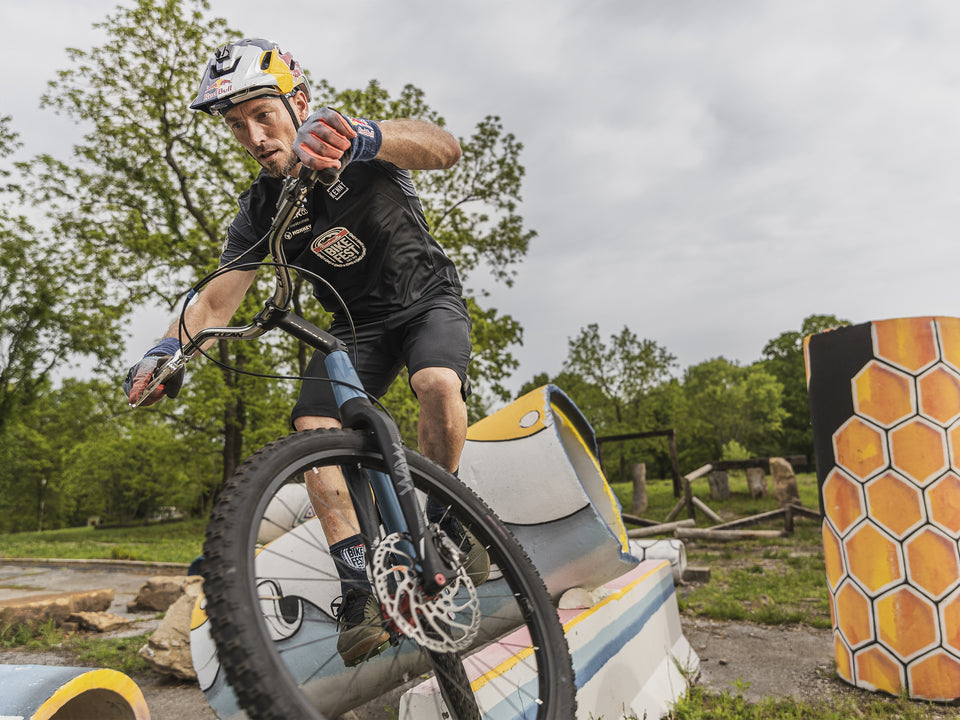 Kenny Belaey riding his mountain bike over obstacles at the Bentonvile Bike Fest event.